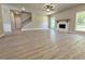Open floor plan living room with fireplace, large windows, and staircase at 3132 Rosebud Rd, Loganville, GA 30052