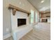 Open concept living space with a white brick fireplace and a view into the modern kitchen at 3132 Rosebud Rd, Loganville, GA 30052