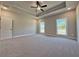 Spacious main bedroom features tray ceiling, neutral color palette, plush carpet and natural light at 3132 Rosebud Rd, Loganville, GA 30052