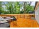 Spacious wooden back deck with seating overlooks the lush, green backyard at 3566 Orchard Dr, Decatur, GA 30032