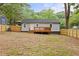Back of home with deck, wooden fence, and a spacious backyard at 3566 Orchard Dr, Decatur, GA 30032