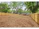 Large, expansive backyard with a new wooden fence and partial view of the house at 3566 Orchard Dr, Decatur, GA 30032