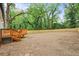 Spacious backyard with a deck, new wooden fence, and mature trees at 3566 Orchard Dr, Decatur, GA 30032