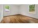 Bright, spacious bedroom with hardwood floors and ample natural light from two windows at 3566 Orchard Dr, Decatur, GA 30032