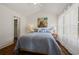 Serene bedroom with vaulted ceiling, hardwood floors, and soft natural light filtering through the window at 3566 Orchard Dr, Decatur, GA 30032