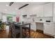 Open concept kitchen with white cabinets, stainless steel appliances, and a dining area at 3566 Orchard Dr, Decatur, GA 30032