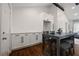 Elegant kitchen area with crisp white cabinetry, dark hardware, and an island providing additional seating at 3566 Orchard Dr, Decatur, GA 30032