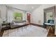 Bright living room with hardwood floors, large windows, and stylish modern furniture at 3566 Orchard Dr, Decatur, GA 30032