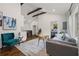 Open-concept living room featuring high ceilings with exposed beams, hardwood floors, and modern furniture at 3566 Orchard Dr, Decatur, GA 30032