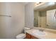 Well-lit bathroom features a large mirror and a classic white sink and toilet at 39 Spring Leaf Pl, Dallas, GA 30157