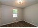 Cozy bedroom features wood-look floors, a window, and a modern ceiling fan at 39 Spring Leaf Pl, Dallas, GA 30157