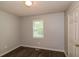 Inviting bedroom with wood-look floors, a window, and neutral paint at 39 Spring Leaf Pl, Dallas, GA 30157