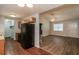 Open-concept kitchen showcasing black appliances, hardwood floors, and a view to the living room at 39 Spring Leaf Pl, Dallas, GA 30157