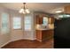 Well-lit eat-in kitchen with wooden cabinets, stainless steel sink, and a rear door at 39 Spring Leaf Pl, Dallas, GA 30157