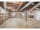 Unfinished basement with exposed ceiling, concrete floor, and wooden shelving at 4807 Kenilworth Dr, Stone Mountain, GA 30083