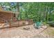 Brick patio with a wooden deck, seating, and lush green surroundings at 4807 Kenilworth Dr, Stone Mountain, GA 30083