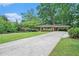 Spacious driveway leading to a brick home with a well-maintained lawn and mature trees at 4807 Kenilworth Dr, Stone Mountain, GA 30083