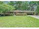 Charming single-story brick home with a well-manicured lawn and covered parking at 4807 Kenilworth Dr, Stone Mountain, GA 30083