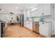 Updated kitchen boasts stainless steel appliances, white cabinets, and granite countertops, adjacent to dining area at 4807 Kenilworth Dr, Stone Mountain, GA 30083