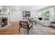 Bright living room with white sofa, fireplace, and large window offering natural light at 4807 Kenilworth Dr, Stone Mountain, GA 30083