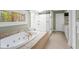 Bright bathroom featuring a soaking tub and glass enclosed shower at 171 Westminster Ne Dr, Atlanta, GA 30309
