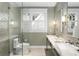 Bright bathroom featuring marble dual sinks and a modern glass-enclosed shower at 171 Westminster Ne Dr, Atlanta, GA 30309