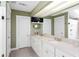 Bright bathroom featuring a double vanity, mirrors, and tile flooring at 171 Westminster Ne Dr, Atlanta, GA 30309
