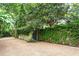 Gravel driveway with a vine-covered wall and mature trees offering privacy at 171 Westminster Ne Dr, Atlanta, GA 30309