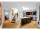 Bright and modern kitchen with island, open staircase, and stainless steel appliances, creating a spacious feel at 171 Westminster Ne Dr, Atlanta, GA 30309