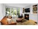 Bright living room boasts hardwood floors, fireplace, built-ins, and french doors to a landscaped garden at 171 Westminster Ne Dr, Atlanta, GA 30309