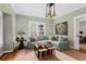 Cozy living room featuring a comfortable gray sectional, hardwood floors, and decorative lighting at 171 Westminster Ne Dr, Atlanta, GA 30309