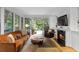 Cozy living room with a fireplace, comfortable seating, and French doors opening to a private outdoor area at 171 Westminster Ne Dr, Atlanta, GA 30309