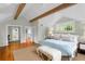 Spacious main bedroom features wood beams, hardwood floors, and large windows at 171 Westminster Ne Dr, Atlanta, GA 30309