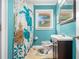 Bright bathroom with blue walls, a turtle-themed shower curtain, and a dark vanity at 2779 Fairlee Dr, Decatur, GA 30032