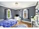 Bedroom displaying a celestial theme, hardwood floors, and large windows with outside views at 2779 Fairlee Dr, Decatur, GA 30032