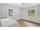 Bedroom showcasing two windows with hardwood floors and a comfortable bed at 2779 Fairlee Dr, Decatur, GA 30032