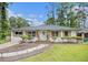 Charming single-story home featuring a landscaped yard, inviting walkway, and a delightful, light blue front door at 2779 Fairlee Dr, Decatur, GA 30032