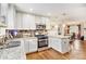 Kitchen featuring granite countertops, stainless steel appliances, and white cabinetry at 2779 Fairlee Dr, Decatur, GA 30032