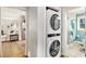 Stacked washer and dryer, with a small view of a bathroom in the home's interior at 2779 Fairlee Dr, Decatur, GA 30032