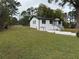 The exterior of this renovated home features a white painted brick and a large sloping yard at 3078 Michael Sw Dr, Marietta, GA 30060