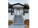 Front exterior view featuring a white painted brick home with black accents and gray painted stairs at 3078 Michael Sw Dr, Marietta, GA 30060