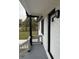 A close-up view of the front porch with fresh gray paint and modern black trim against white brick at 3078 Michael Sw Dr, Marietta, GA 30060