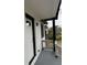 Inviting front porch with fresh gray paint, black trim, and a stylish exterior light fixture at 3078 Michael Sw Dr, Marietta, GA 30060