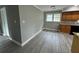 Open-concept eat-in kitchen featuring wood cabinets, stone countertops, and sleek gray flooring at 3078 Michael Sw Dr, Marietta, GA 30060