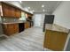 Functional kitchen with wood cabinets, stone countertops, mosaic backsplash, and gray wood-look flooring at 3078 Michael Sw Dr, Marietta, GA 30060
