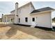 Two-story home with neutral siding, black mulch, a covered patio, and large windows providing ample natural light at 3154 Rosebud Rd, Loganville, GA 30052
