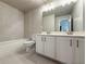 Well-lit bathroom featuring a double vanity, a bathtub, and tiled floors at 3154 Rosebud Rd, Loganville, GA 30052