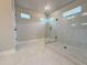Bright bathroom featuring a glass-enclosed shower and a vanity at 3154 Rosebud Rd, Loganville, GA 30052