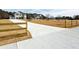 Long concrete driveway leads to the house, accented by split rail fence and expansive front yard at 3154 Rosebud Rd, Loganville, GA 30052