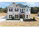 Newly constructed home with architectural details, modern windows, and professional landscaping at 3154 Rosebud Rd, Loganville, GA 30052
